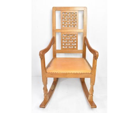 Robert 'Mouseman' Thompson (1876-1955) An oak rocking chair, circa 1974, with two lattice panel backs, shaped arms and close 