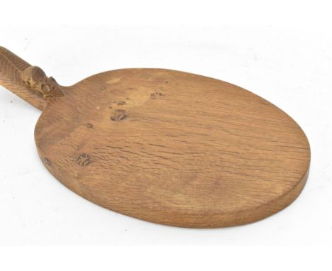 Robert 'Mouseman' Thompson (1876-1955) An adzed oak cheeseboard, oval form with projecting handle carved with mouse signature