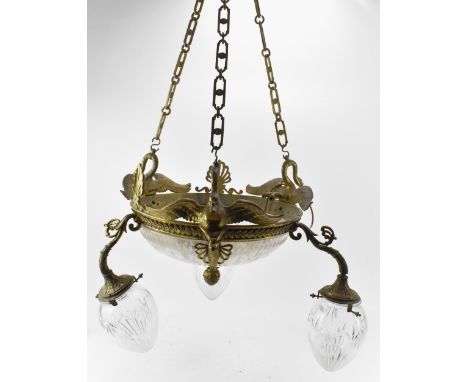 An early 20th century French gilt metal Empire style chandelier, the chains supported by three swans, surrounded by pierced p