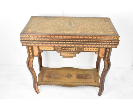 A late 19th/early 20th century Syrian Damascus games table - with typical intricate marquetry inlay in exotic hardwoods and m