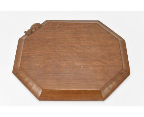 Robert 'Mouseman' Thompson (1876-1955) An adzed oak breadboard, circa 1984, extended octagonal form with moulded edge carved 