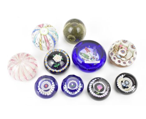 A collection of ten mixed paperweights, comprising Murano latticino, Caithness lampwork floral examples to include one by Wil