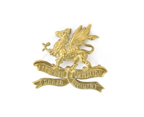 A rare first world war brass cap badge to Eleventh Battalion Border Regiment, with tablet to the reverse engraved 'J.R. Gaunt