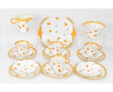 An Art Deco Shelley orange polka dot pattern part tea service, Regent shape, circa 1932-4, comprising four cups six and sauce