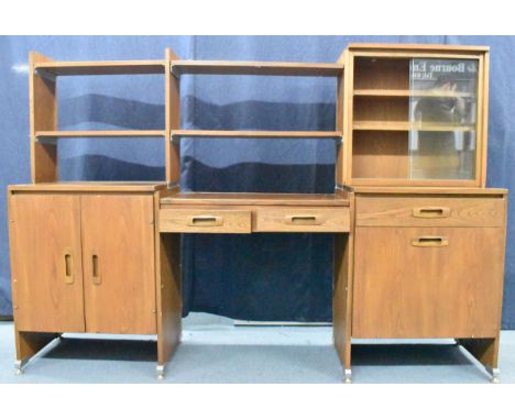 A 1960s light elm desk, having a glazed section with two sliding doors and open shelves, above drawers and cupboard doors, ra