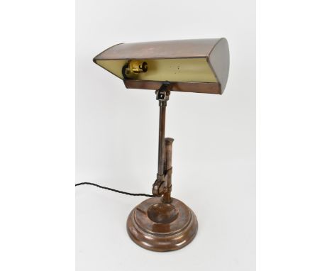 An Art Deco copper banker's desk lamp with hooded shade, over an adjustable column support to weighted domed circular base 46