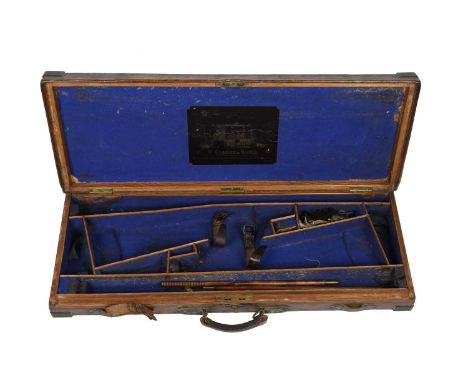 A vintage leather covered and brass bound double gun case, made for a pair of guns of approximately 28 inch barrel length, fi