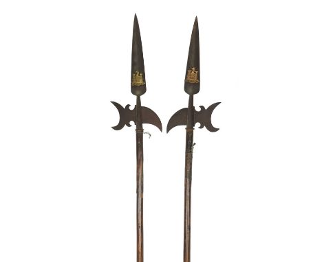 A pair of ornamental halberds, heads with crescent-shaped axe blades and curved rear spikes and surmounted by long spear poin