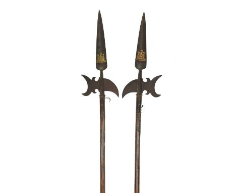 A pair of ornamental halberds, heads with crescent-shaped axe blades and curved rear spikes and surmounted by long spear poin