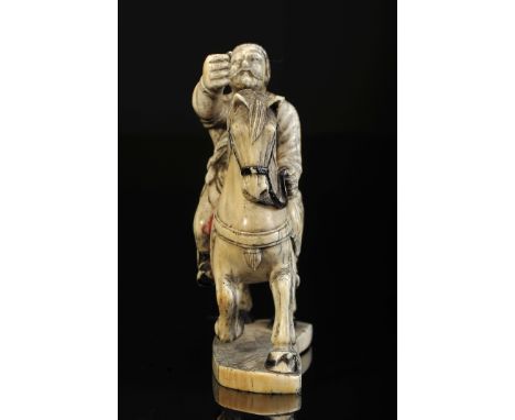 A man on horseback, ivory sculpture partially painted black and red, Chinese, 19th C., sword missing, wear on decoration, Dim