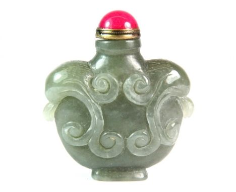 A Chinese carved celadon jade snuff bottle with gilt and pink hard stone stopper H 6cm