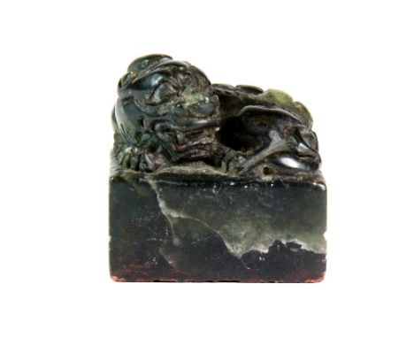 A Chinese dark green soapstone seal mounted with a young dragon 4cm x 4cm x 4cm