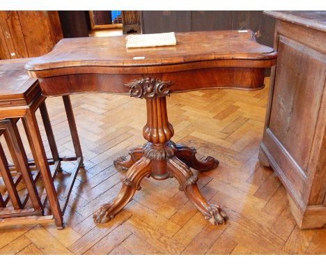 An early Victorian rosewood swivel top card table with baize lined interior, on reeded column support with four carved splay 