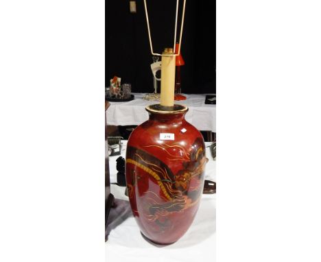 A large oriental style jar painted with a dragon, on dark red ground, converted to a table lamp (af) 