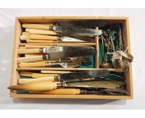 A quantity of cutlery including steel bladed knives, serving knife and fork, etc. 