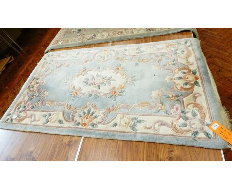 Chinese wool rug on pale blue ground, floral and scroll decoration, white guards and light blue border, 170cm x 90cm 