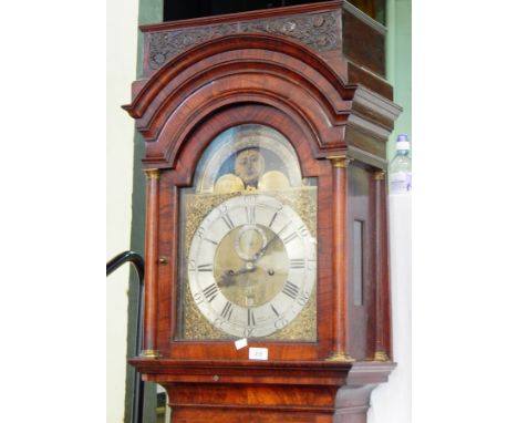 An 18th century walnut longcase clock, with canopied hood, brass dial with silvered chapter ring, and chased spandrels with m