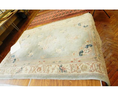 Chinese wool rug on pale blue ground, floral and scroll decoration, white guards and light blue border, 2m x 1.22m 