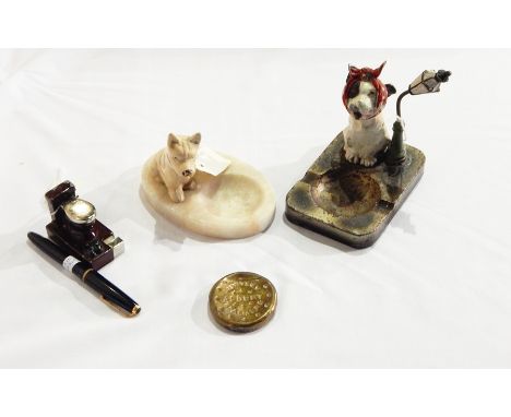 A Huntley & Palmer vesta case, brass, 19th century lighter in the shape of a toilet, metal ashtray dog of sitting under a lam