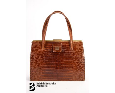 A vintage Asprey handbag, tan alligator skin, circa 1960s, with twin handles, gold tone hardware with sliding lock, fitted be