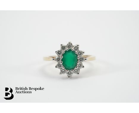 9ct yellow gold, green and white stone ring. The ring set with an oval green stone approx 8 x 6mm, surrounded by white stones