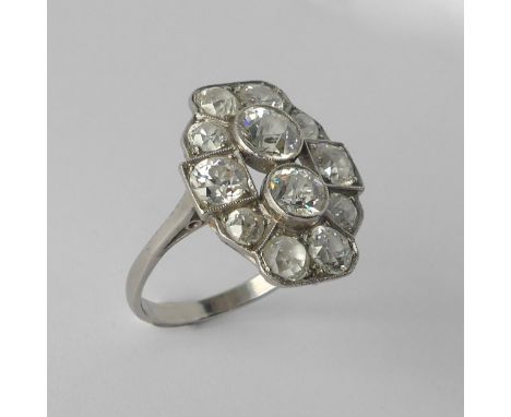 An Art Deco diamond Cluster Ring, the old cut stones millegrain set in platinum on a plain shank, the largest diamond approx.