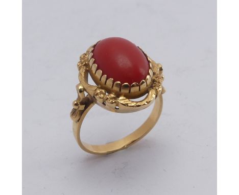 A coral Dress Ring, the oval cabochon stone approx. 14mm long, mounted in 18ct yellow gold, Size N½, total weight 5.5g. 