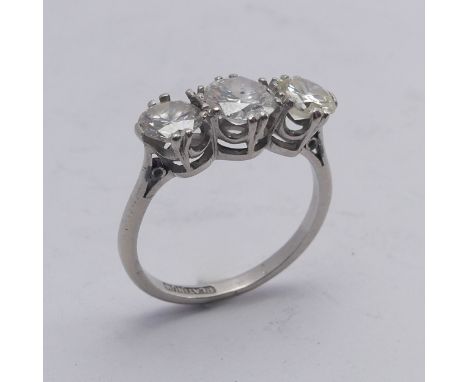 A three stone diamond Ring, the centre stone approx. 0.8ct, with a smaller stone on either side, one approx. 0.62ct, the othe