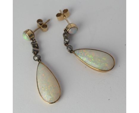 A pair of opal drop Earrings, the pear shaped stones approx. 17.8mm long collet set in yellow gold below three millegrain set