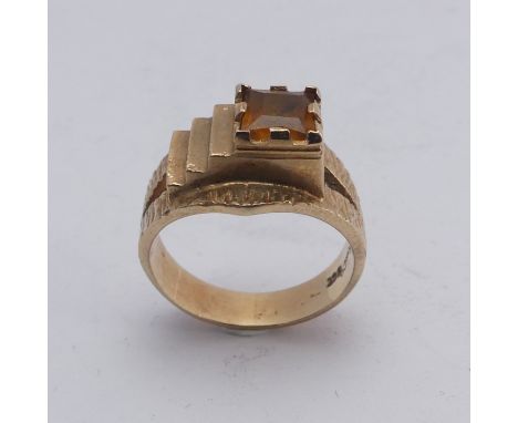 A 1970's style 9ct gold and citrine Ring, the square facetted stone in offset textured mount with split shoulders, Size M½, 5