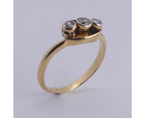 A small three stone diamond Ring, millegrain set on the cross in 18ct yellow gold and platinum, Size L, 2.5g. 