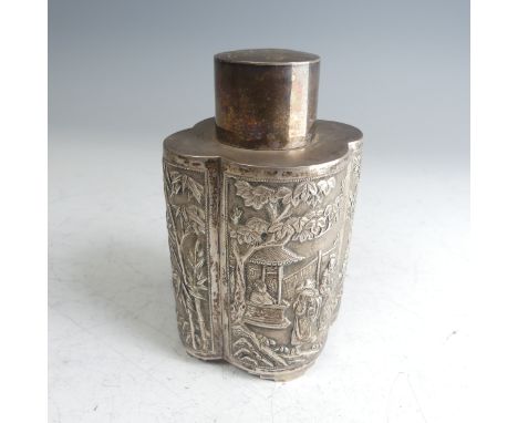 A Chinese export silver Tea Caddy, of lobed oval form with pull off circular cover, one side with figural decoration, the oth
