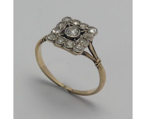 A small Art Deco diamond cluster Ring,&nbsp;the squared front with central diamond within a surround of smaller stones, all m