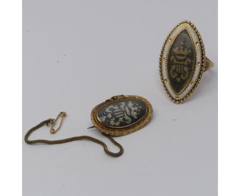 A 19thC Memorial Ring, the navette shaped front with white enamel and beaded border, the centre with wool work crest, 3.1cm l