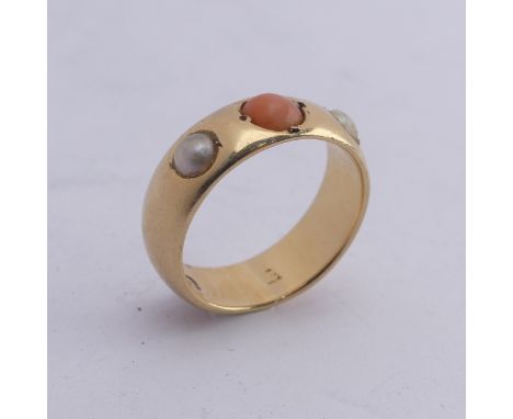 A coral and cultured pearl three stone Ring, the 18ct yellow gold band set with central circular pale coral with a cultured p