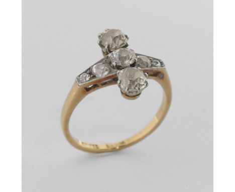 A diamond Ring, the front with a graduated row of five old cut stones, the centre stone approx. 0.25ct, with a larger stone c