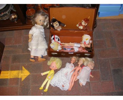 A quantity of vintage dolls and plush toys in child's leather suitcase 