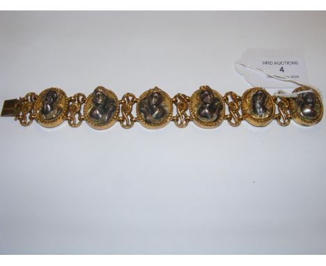 A heavy yellow metal six panel relief bracelet 