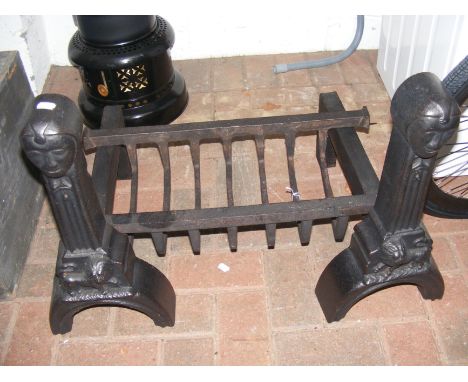 A pair of cast iron fire dogs and fire grate 
