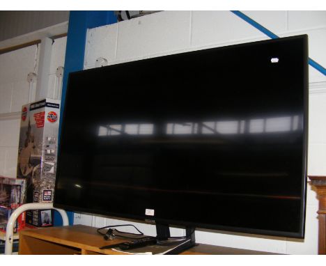 A Samsung UHD TV - with remote and User Manual  