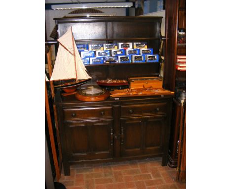 A dark wood Ercol dresser with plate rack to back - width 123cm 