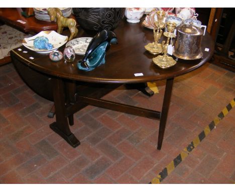 A mid century dark wood Ercol gate-leg table 