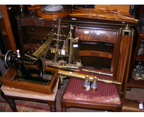An antique Singer sewing machine, together with a brass telescope on stand and metal ship model, etc. 
