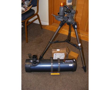 A Celestron AstroMaster 130 astronomical telescope with stand and accessories
