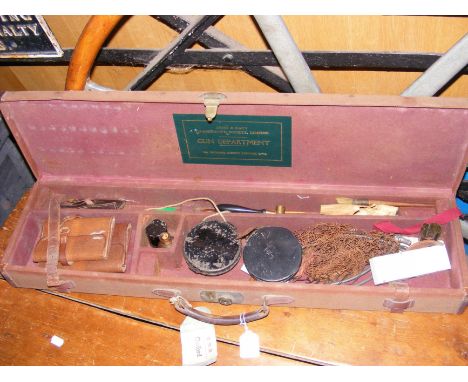 An old Army & Navy gun case, containing a selection of vintage fishing and other accessories 
