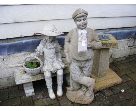 A garden statue of golfer, together with girl on bench ornament and a small sundial