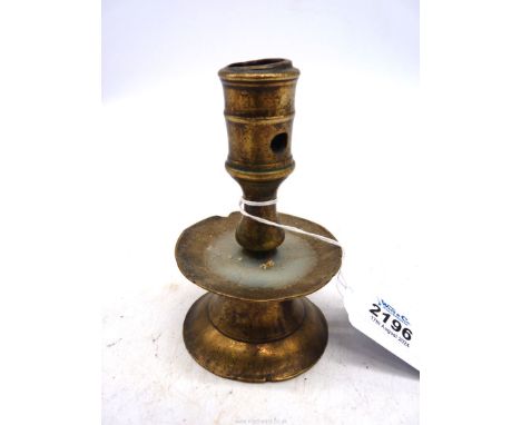 A mid 16th century Flemish brass candlestick, the socket with two extraction holes above a drip pan and flared base  4 1/2" t