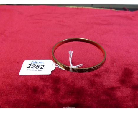 A 9ct gold on metal core Bangle.