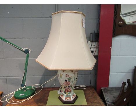A ceramic table lamp base with floral and butterfly detail with shade