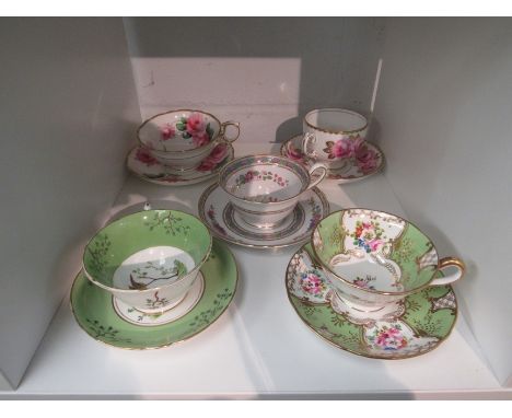 Five cups and saucers decorated internally with flowers, birds etc